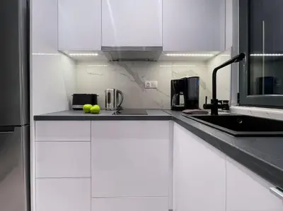 a kitchen with white cabinets and a sink at Lucky Elegant Home #12 VIPGreece in Athens