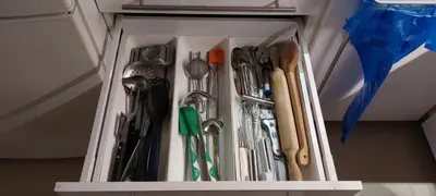 a drawer filled with utensils in a cabinet at Κατερινα in Athens