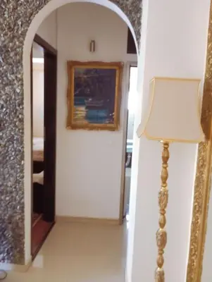 a hallway with a mirror and a lamp in a room at Κατερινα in Athens