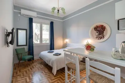 a room with a bed and a table and chairs at Troon of Athens House in Athens