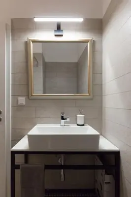 a bathroom with a white sink and a mirror at Troon of Athens House in Athens