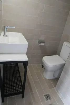 a bathroom with a white sink and a toilet at Troon of Athens House in Athens