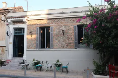 a group of chairs and tables outside of a building at Troon of Athens House in Athens