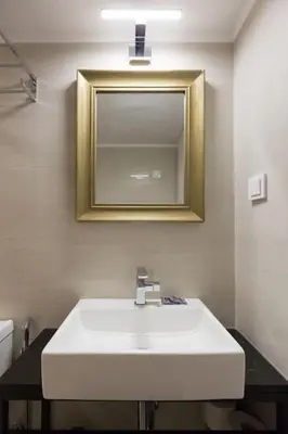 a bathroom with a white sink and a mirror at Troon of Athens House in Athens