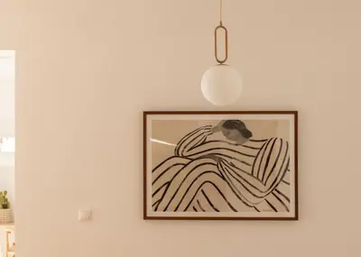 a picture hanging on a wall with a light fixture at Urban Athéna Apartment,Pangrati in Athens