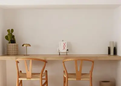 two wooden chairs sitting under a wooden shelf at Urban Athéna Apartment,Pangrati in Athens