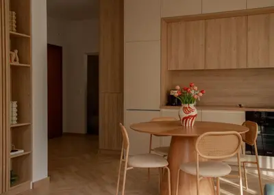a kitchen with a table with chairs and a vase of flowers at Urban Athéna Apartment,Pangrati in Athens