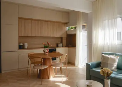 a kitchen and living room with a table and a couch at Urban Athéna Apartment,Pangrati in Athens