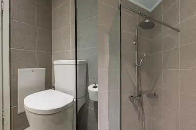 a bathroom with a toilet and a glass shower at The Hill by Zoia Living in Athens