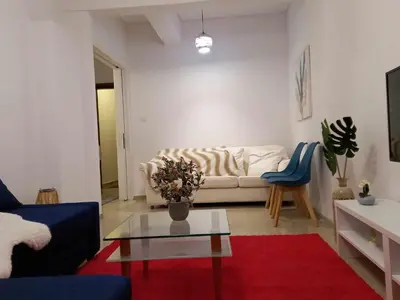 a living room with a couch and a table at Citrus dream apartment in Athens