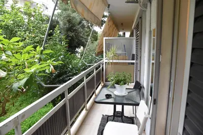 a balcony with a table and plants on it at Citrus dream apartment in Athens