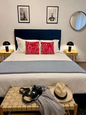 a bedroom with a bed with a camera on a table at Centrum Athens Apt. in Athens