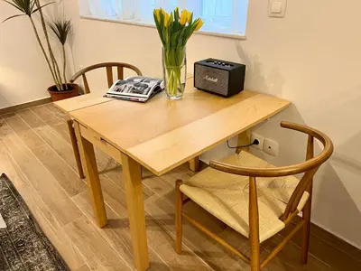 a wooden table with a vase of flowers and a radio at Centrum Athens Apt. in Athens