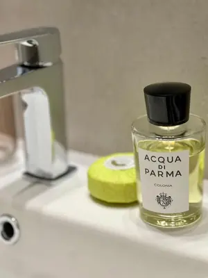a bottle of perfume sitting on a bathroom counter at Centrum Athens Apt. in Athens