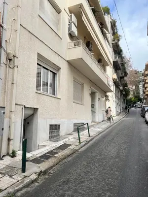 an empty street in front of a building at Centrum Athens Apt. in Athens