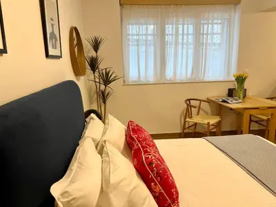 a bedroom with a bed with red and white pillows at Centrum Athens Apt. in Athens