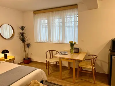 a bedroom with a table and chairs and a bed at Centrum Athens Apt. in Athens