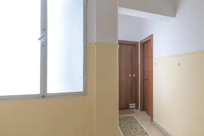 an empty room with a window and a hallway at Sunny Central Luxury 50 sm with balcony view 4th floor in Athens