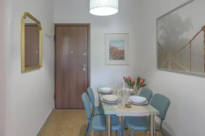 a dining room with a table and blue chairs at Sunny Central Luxury 50 sm with balcony view 4th floor in Athens