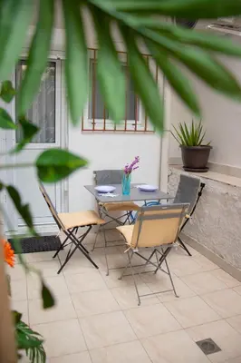 a patio with a table and chairs on a patio at Moon Haven Near Acropolis with 100Mbps WiFi in Athens