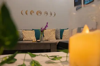 a living room with a couch and a table with flowers at Moon Haven Near Acropolis with 100Mbps WiFi in Athens
