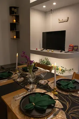 a dining room table with green plates and candles at Moon Haven Near Acropolis with 100Mbps WiFi in Athens