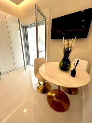 a table with a vase on it in a room at Boutique3436 Luxury Apartment in Athens