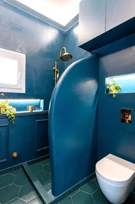 a blue bathroom with a toilet and a sink at Boutique3436 Luxury Apartment in Athens