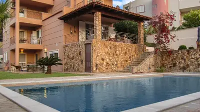 a house with a swimming pool in front of a building at Escape pool villa in Anavissos in Athens