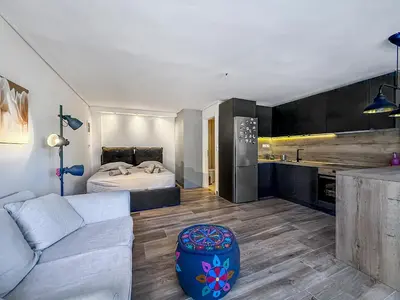 a living room with a couch and a bed at Escape pool villa in Anavissos in Athens