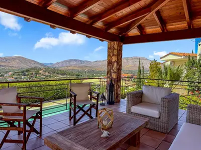 a patio with chairs and a table and a view at Escape pool villa in Anavissos in Athens