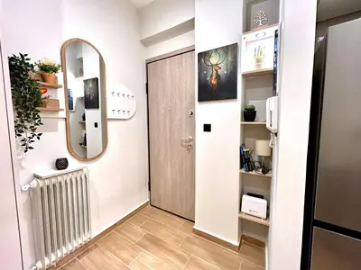 a hallway with a door and a mirror at Elegant & Stylish 2nd Floor Flat - 3' from Metro in Athens