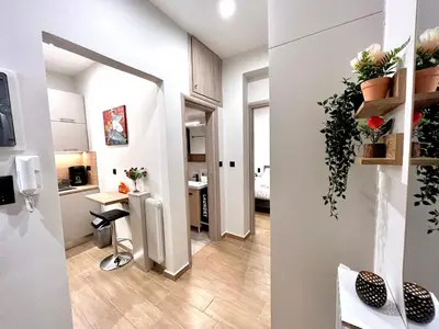 a small apartment with a kitchen and a living room at Elegant & Stylish 2nd Floor Flat - 3' from Metro in Athens