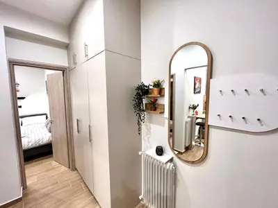 a mirror on a wall next to a bedroom at Elegant & Stylish 2nd Floor Flat - 3' from Metro in Athens