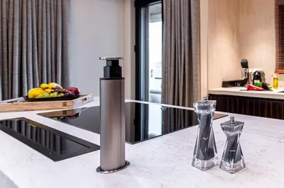 a kitchen counter with two vases on a table at OPULENT PENTHOUSE 1 in Vari