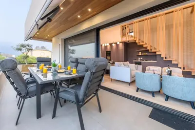 a dining room with a table and chairs at OPULENT PENTHOUSE 1 in Vari