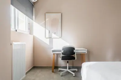 a bedroom with a desk and a chair at Snug by Zoia Living in Athens