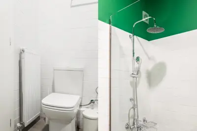 a bathroom with a toilet and a shower at Snug by Zoia Living in Athens