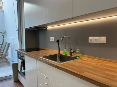 a kitchen with a sink and a wooden counter top at Flat in Thissio in Athens