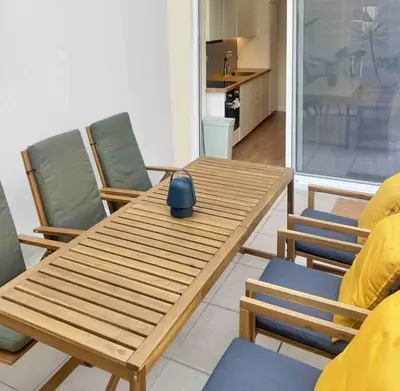 a wooden table and chairs in a living room at Flat in Thissio in Athens