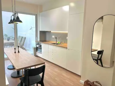 a kitchen with a dining table and a mirror at Flat in Thissio in Athens