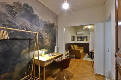 a living room with a painting on the wall at Cosy apartment in Glyfada in Athens