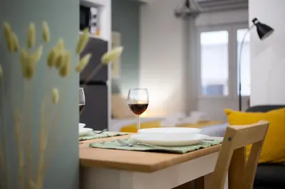 a table with two glasses of wine on it at Athens Gem Retreat in Athens