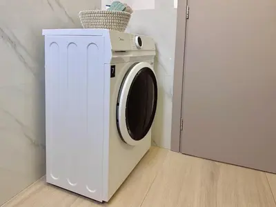 a white washing machine next to a white refrigerator at Kasaj Luxury Apartments in Porto Rafti