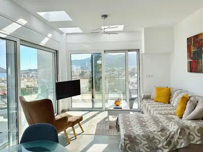 a living room with a couch and a tv at Kasaj Luxury Apartments in Porto Rafti