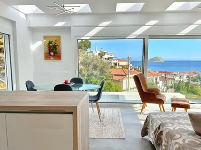 a living room with a view of the ocean at Kasaj Luxury Apartments in Porto Rafti