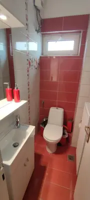 a bathroom with a white toilet and a sink at Spacious flat ideal for families in Athens