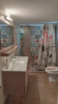 a bathroom with a sink and a shower with a toilet at Spacious flat ideal for families in Athens