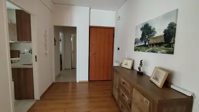 a kitchen with a wooden dresser in a room at Spacious flat ideal for families in Athens
