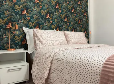 a bedroom with a bed with a floral wallpaper at Kallithea Zen Studios-Near Filopappou & Koukaki in Athens
